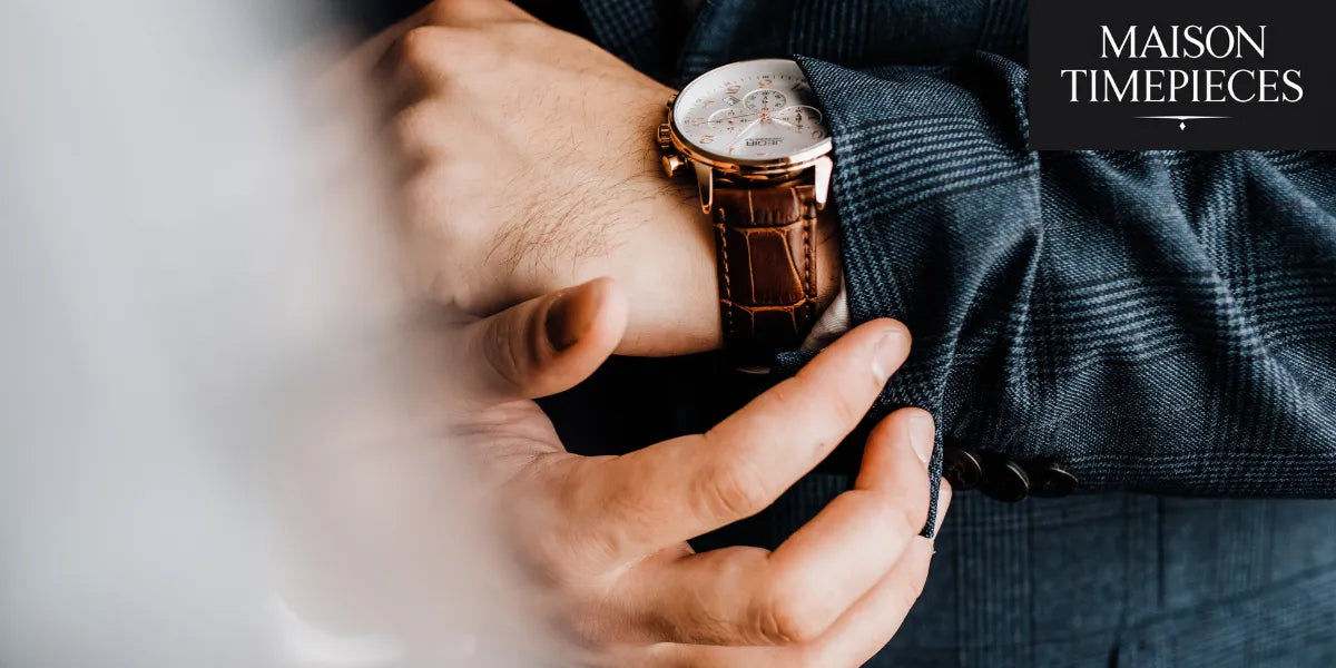 Man adjusting his luxury wristwatch with brown leather strap — Maison Timepieces Singapore