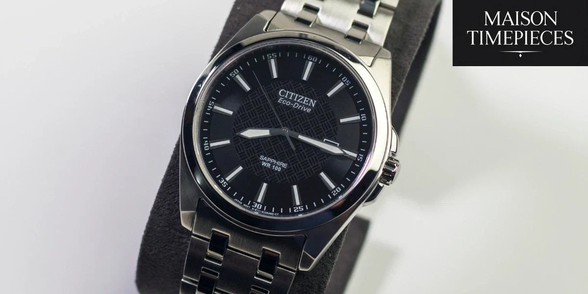 Close-up of a Citizen Eco-Drive men’s watch with black dial and silver bracelet, featured by Maison Timepieces