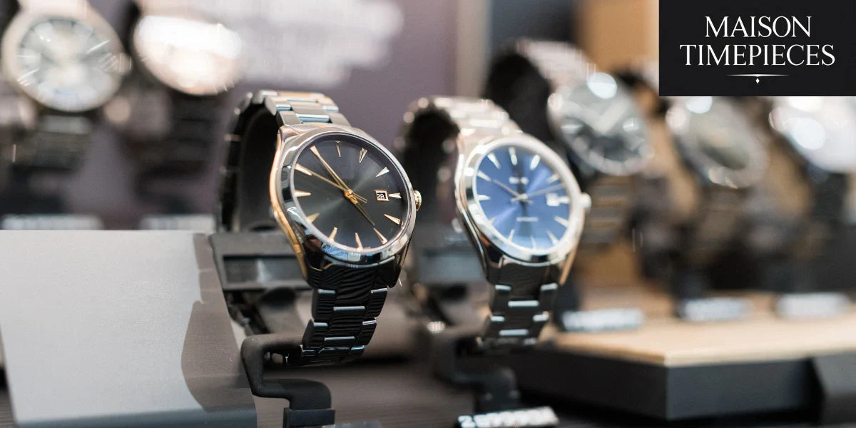 Luxury men's watches with black and blue dials on display at Maison Timepieces
