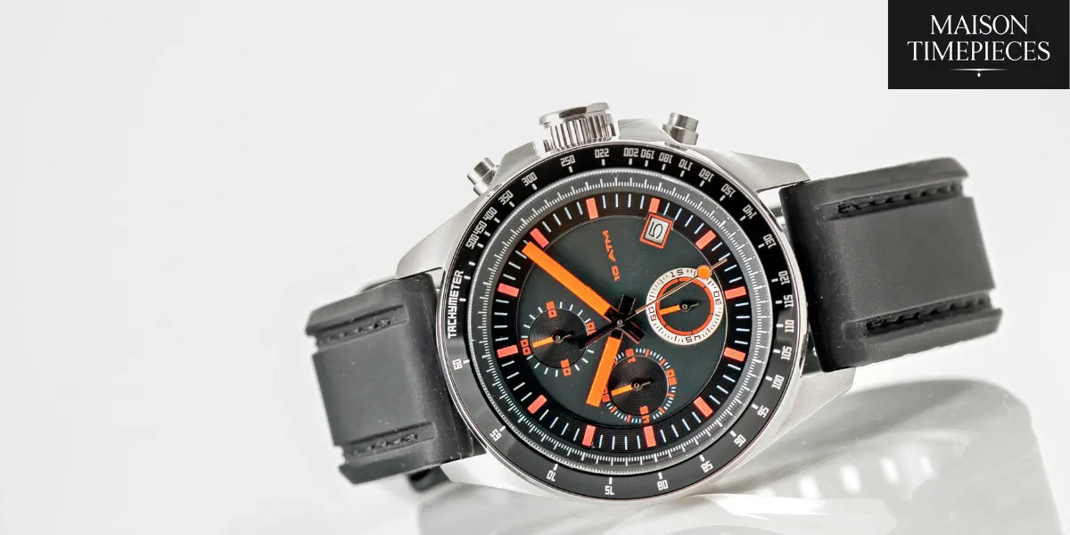 “Sporty chronograph wristwatch with black and orange design on rubber strap — photographed for Maison Timepieces.”