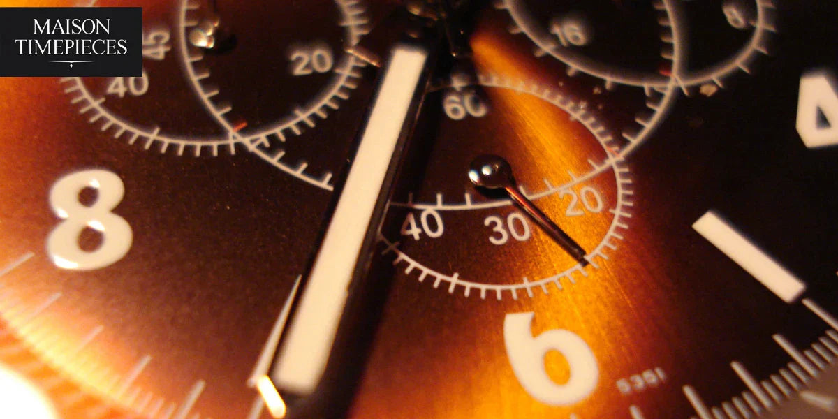 Close-up detail of a chronograph watch dial with metallic finish by Maison Timepieces