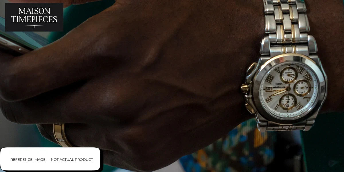 Vario chronograph stainless steel watch with Roman numeral dial on metal bracelet worn on wrist close-up