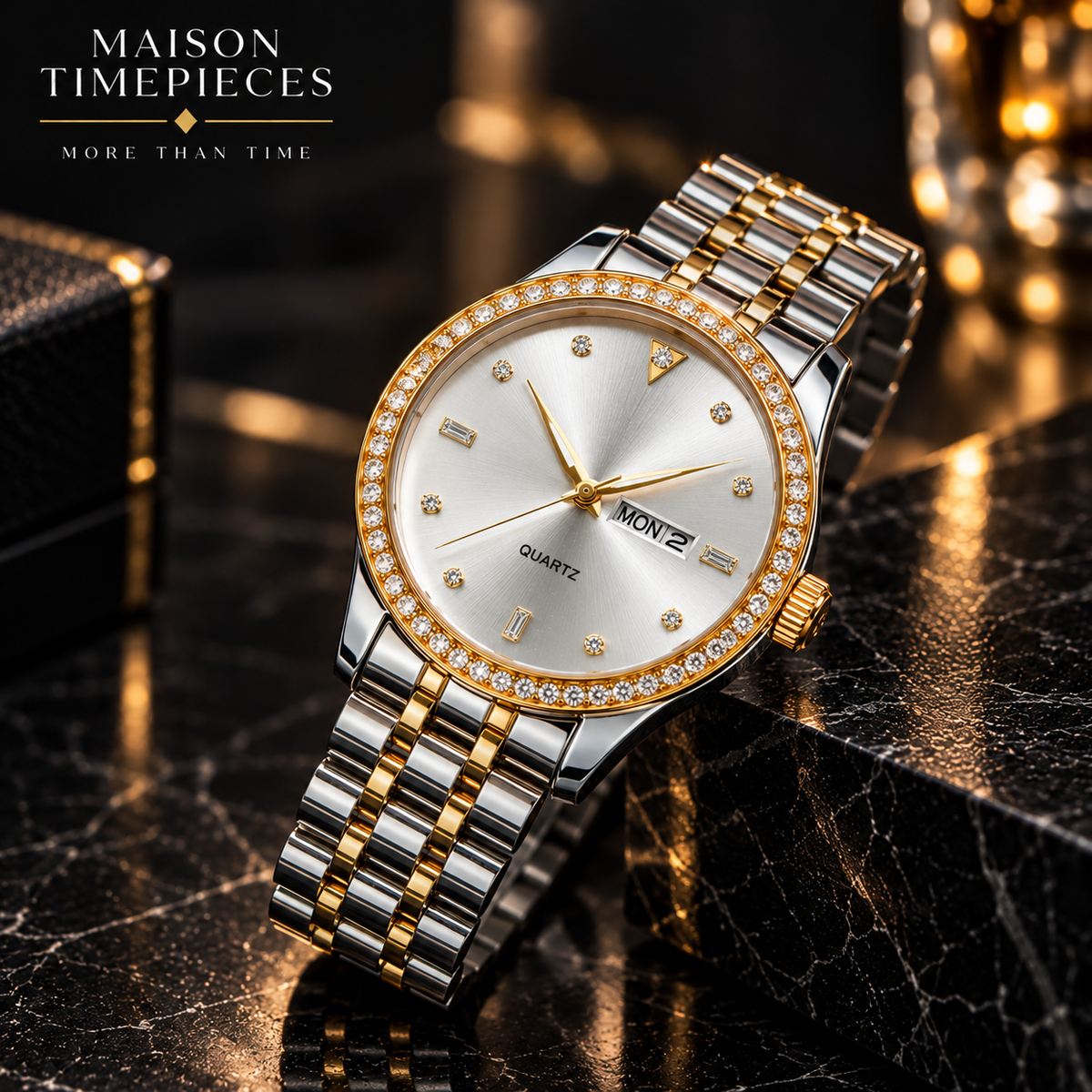 A two-tone stainless steel and gold watch with a diamond-crystal bezel, silver and gold link bracelet, and a white dial, displayed on a black marble surface with a black leather box in the background. The text 'MAISON TIMEPIECES MORE THAN TIME' is visible in the top left corner.