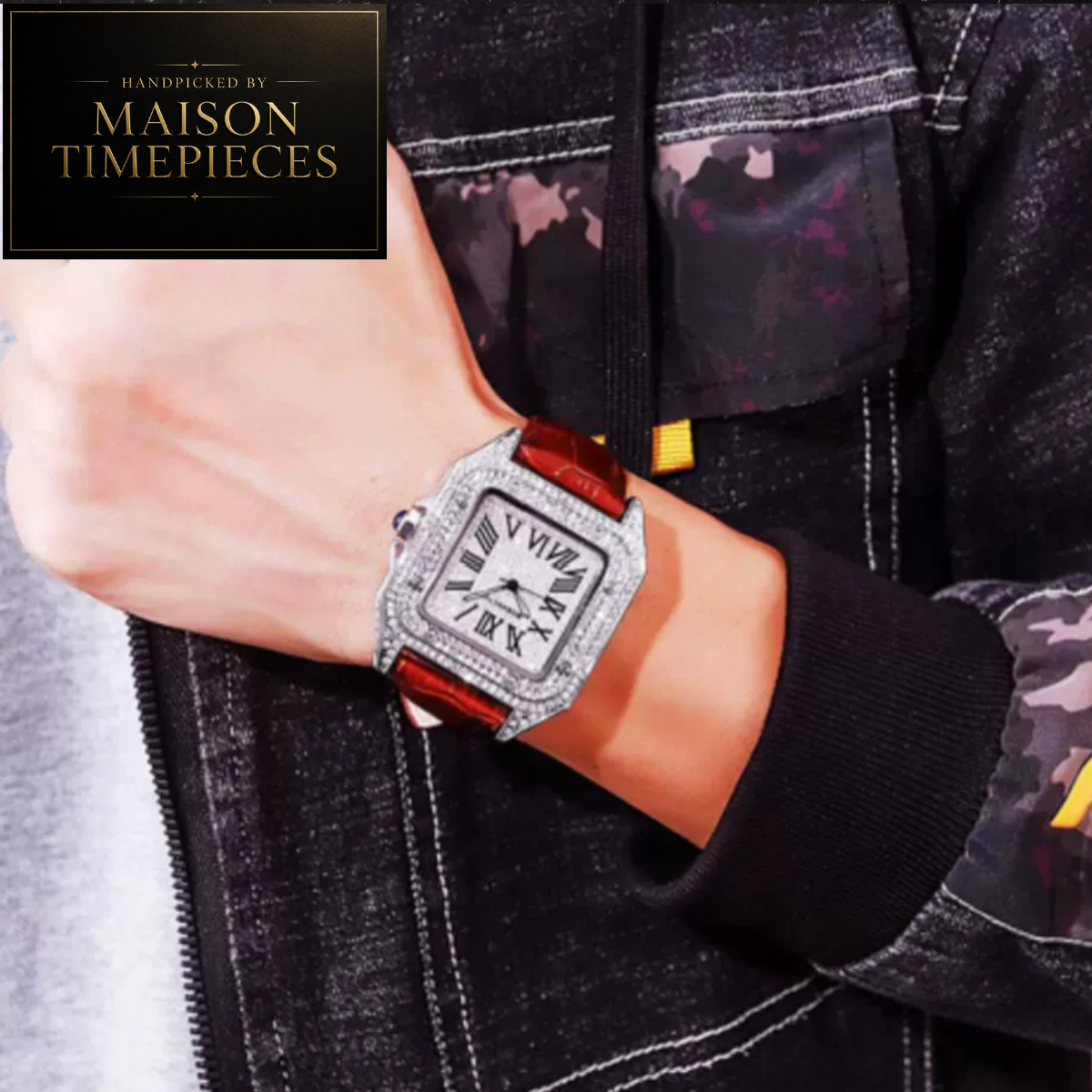 A close-up of a person's wrist wearing a square-faced watch with a silver rhinestone bezel, white dial, and reddish-brown strap. The person is wearing a black zip-up jacket with a camouflage pattern on the sleeve.