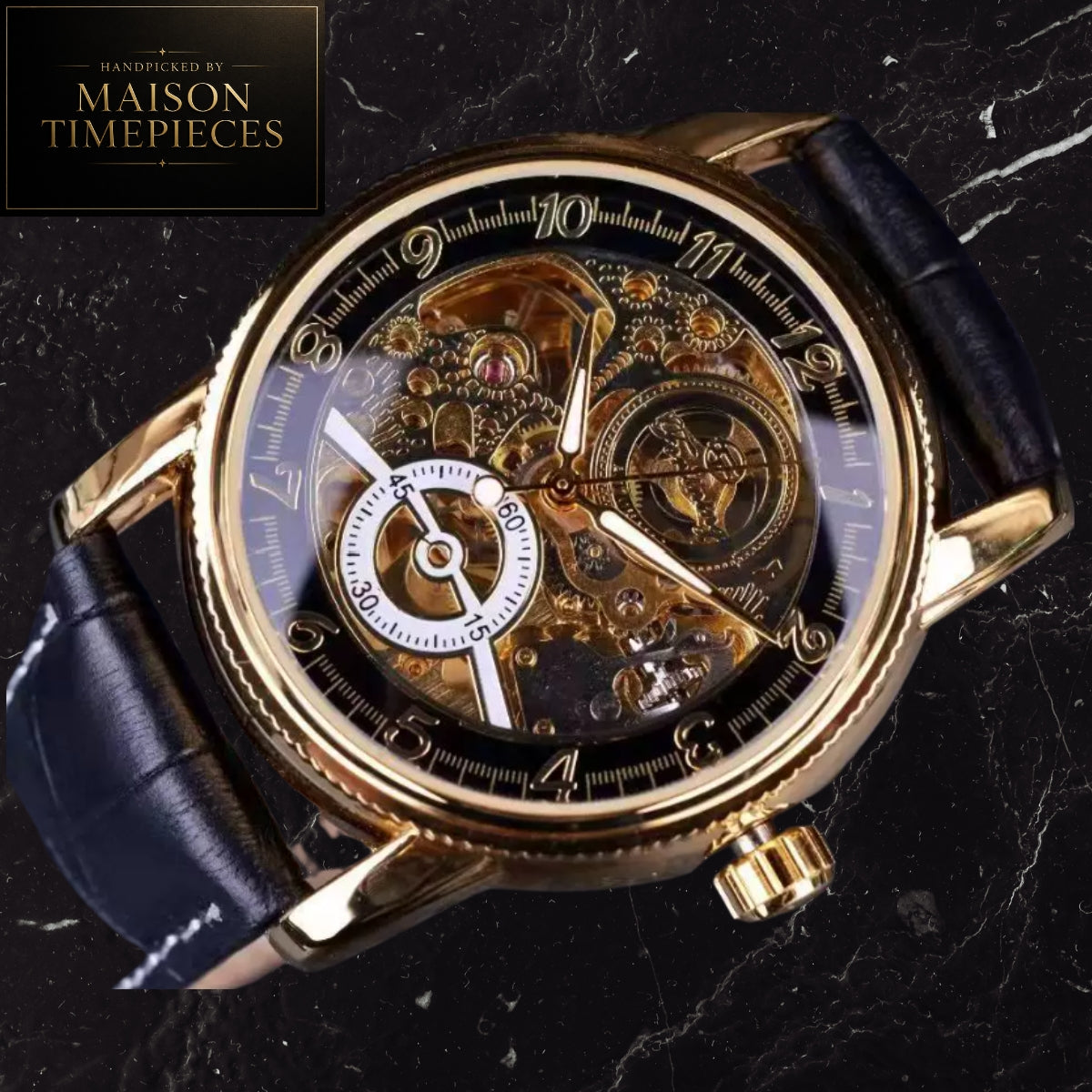 A luxury skeleton watch with a gold-tone case, transparent dial showing intricate internal gears, a white subdial at 9 o'clock, and a black leather strap, set against a dark marble background with a Maison Timepieces logo in the top-left corner.