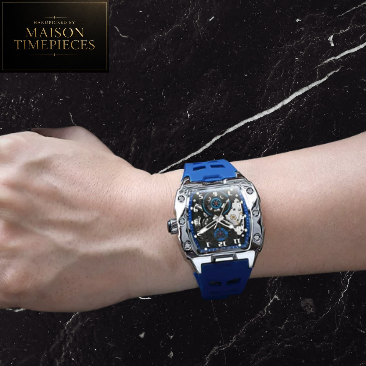 Maison Timepieces Curated automatic skeleton sports watch with 43mm black tonneau case, visible mechanical movement, orange silicone strap, luminous hands and transparent exhibition caseback.