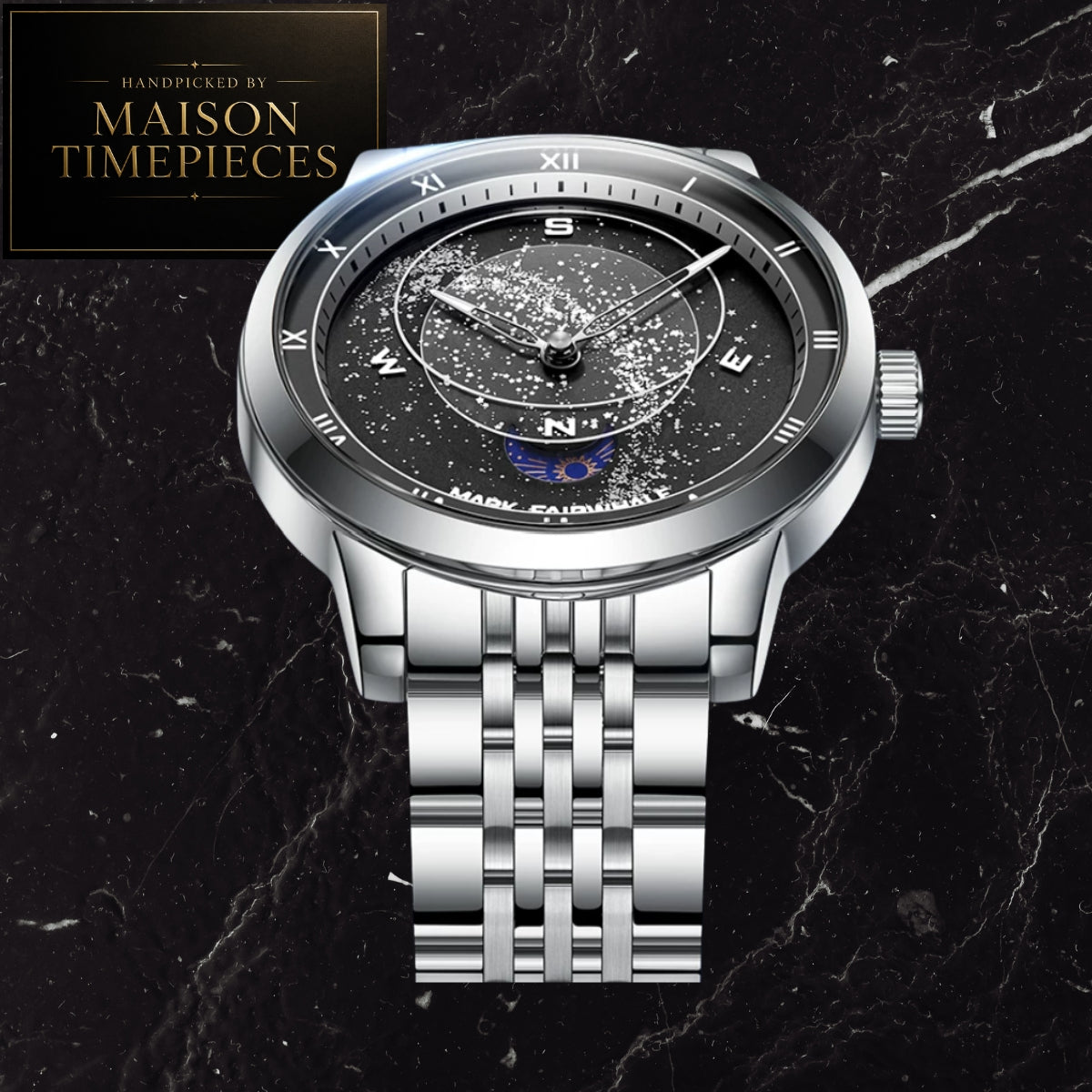A silver stainless steel wristwatch with a black dial featuring a starry outer ring and a blue moon phase sub-dial. The watch is displayed on a black marble background with a 'MAISON TIMEPIECES' logo in the top-left corner.