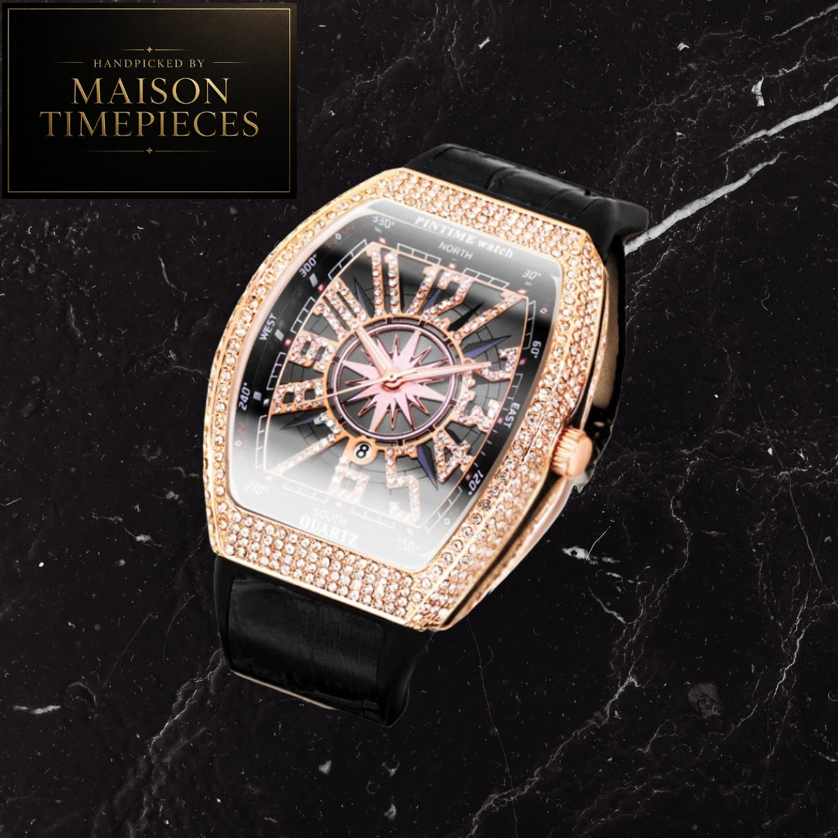 A luxury watch by Maison Timepieces featuring a rose gold case and bezel paved with small clear stones, a black dial with gold Roman numerals, and a black leather strap, displayed on a black marble background.