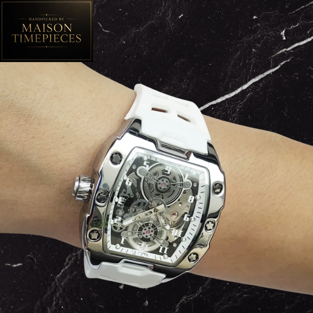 Maison Timepieces Curated automatic skeleton sports watch with 43mm black tonneau case, visible mechanical movement, orange silicone strap, luminous hands and transparent exhibition caseback.