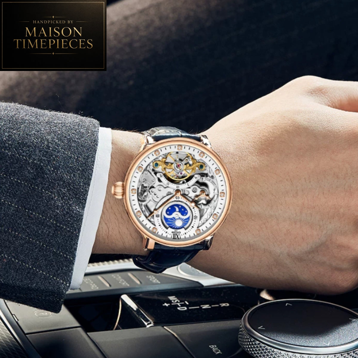 A close-up lifestyle shot of a Maison Timepieces skeleton watch on a person's wrist. The watch features a rose gold case, a clear crystal dial showing the intricate mechanical movement, a blue moon phase indicator, and a dark leather strap.