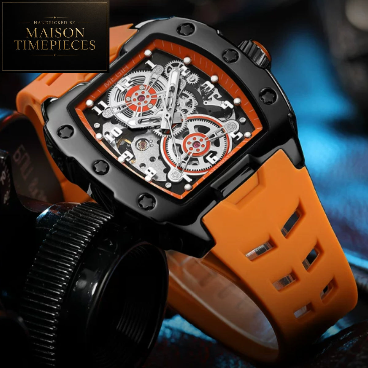 Maison Timepieces Curated automatic skeleton sports watch with 43mm black tonneau case, visible mechanical movement, orange silicone strap, luminous hands and transparent exhibition caseback.