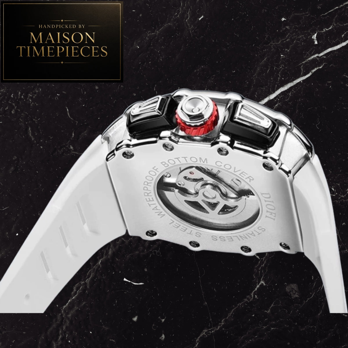 A close-up of the back of a Maison Timepieces watch with a polished silver-tone case, white strap, black and red crown details, and engraved text on the bottom cover, set against a black marble background.