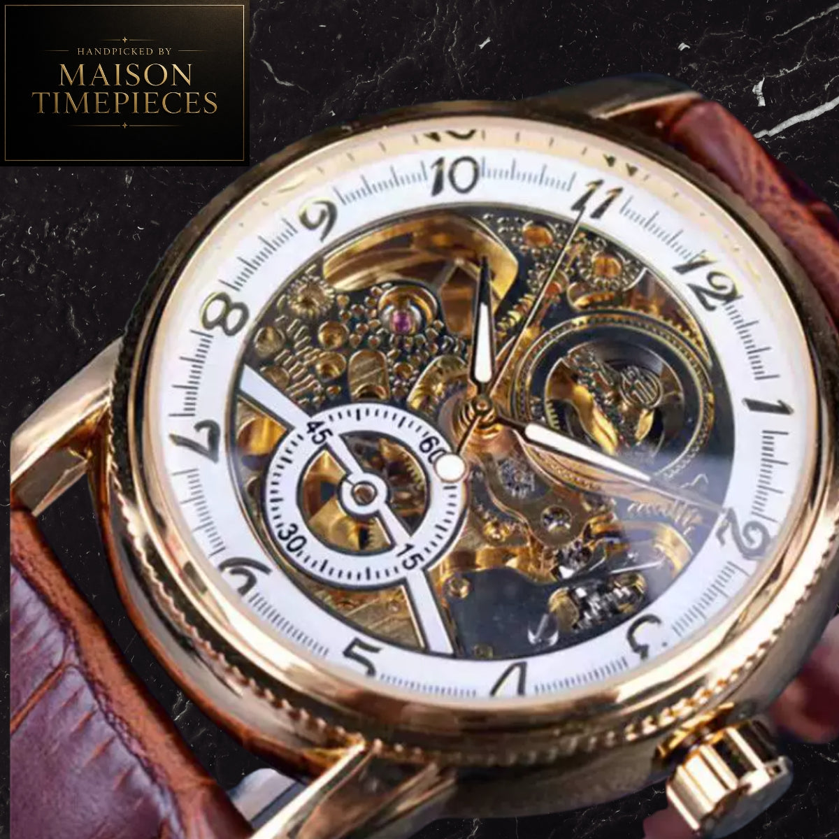 A close-up of a skeleton watch with a gold-tone case, white dial, and visible mechanical movement. A brown leather strap is partially visible on both sides.