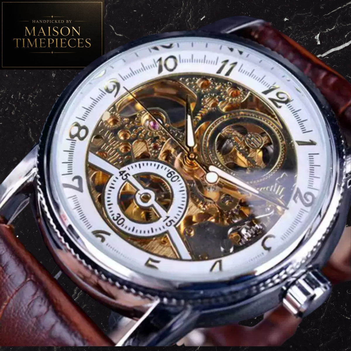 A close-up of a skeleton watch with a white dial, black Arabic numerals, and a highly visible gold-tone mechanical movement. The watch has a silver-tone case and a brown leather strap, shown against a dark textured background.