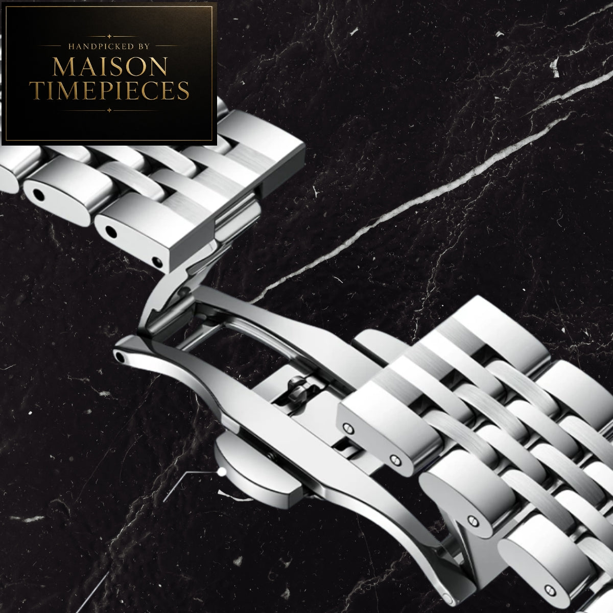 A close-up of a polished silver stainless steel watch band clasp and links, shown on a black marble background with a Maison Timepieces logo in the top-left corner.