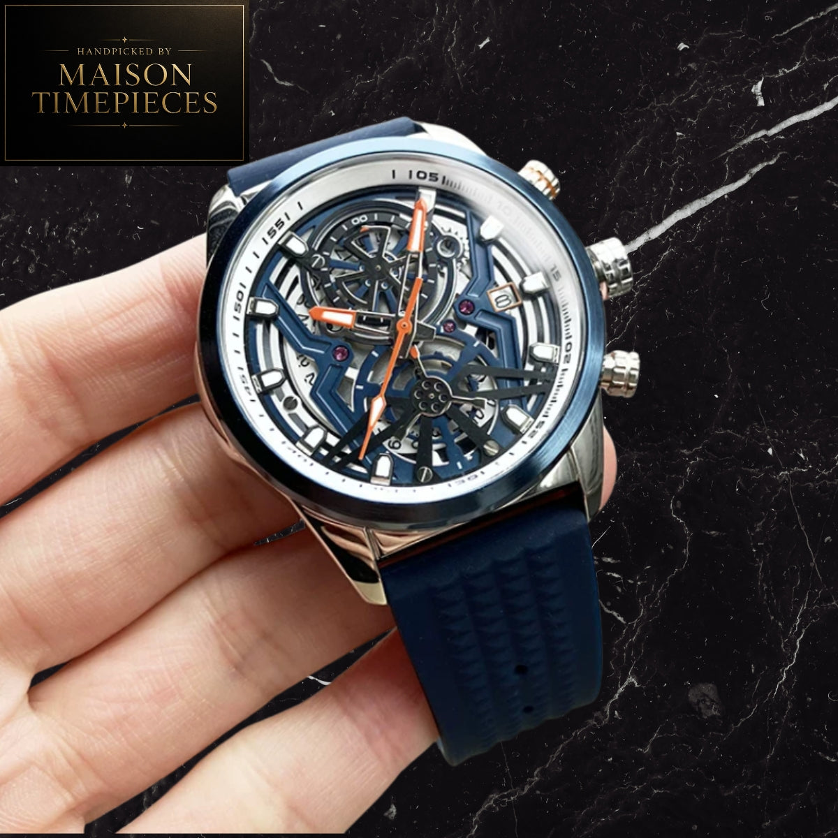 Maison Timepieces Curated skeleton quartz sports watch with black open-work dial, orange silicone strap, luminous hands, date display and 44mm alloy case.
