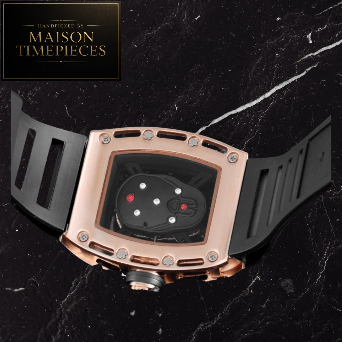 Maison Timepieces Curated skeleton tonneau quartz watch with gold crystal-set case, black skeleton dial, Japanese quartz movement and black silicone strap.