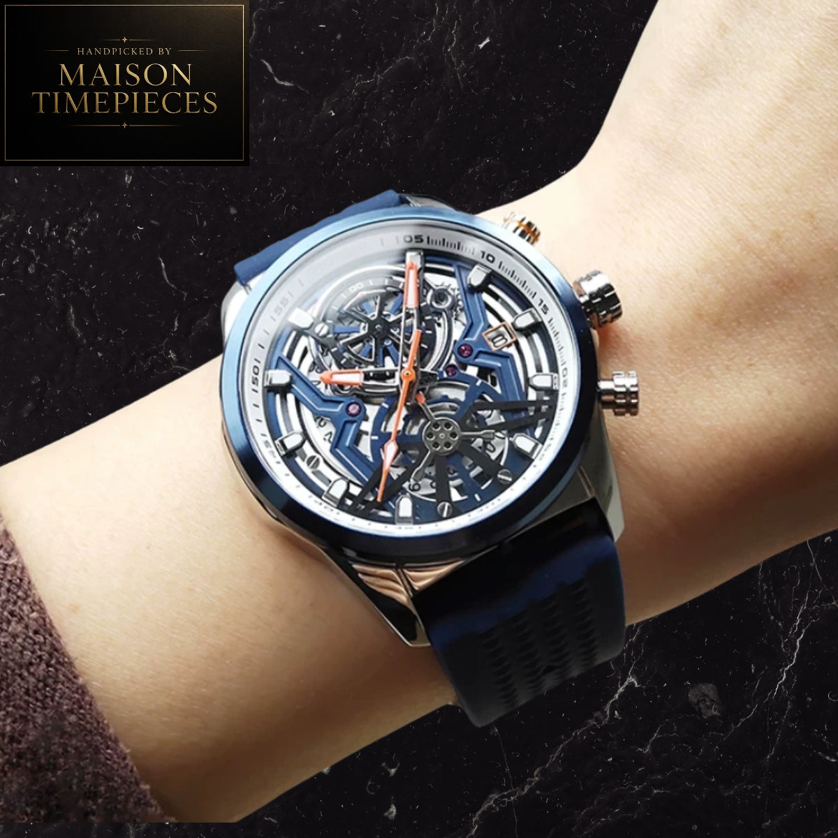Maison Timepieces Curated skeleton quartz sports watch with black open-work dial, orange silicone strap, luminous hands, date display and 44mm alloy case.