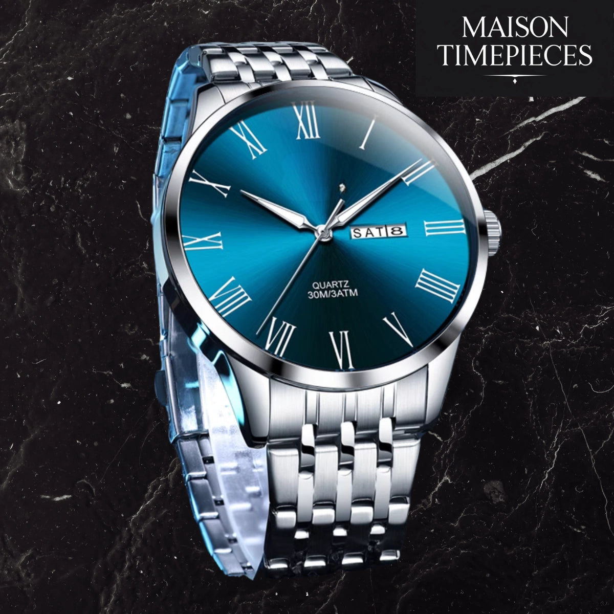 Silver watch with blue dial on a dark marble background, branded 'Maison Timepieces'.