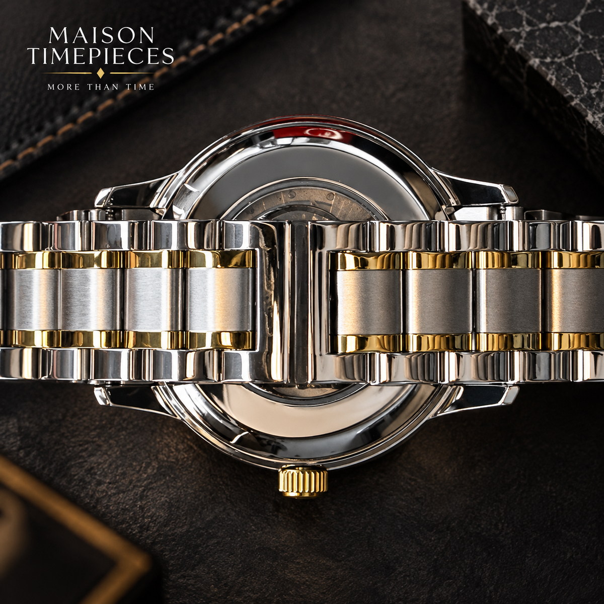Automatic watch caseback with two-tone stainless steel bracelet and gold-tone detailing.