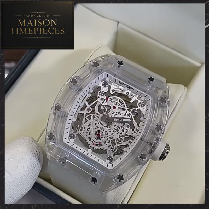 Maison Timepieces Curated automatic skeleton transparent tonneau watch with clear case, white silicone strap, 44mm case and exposed mechanical movement.