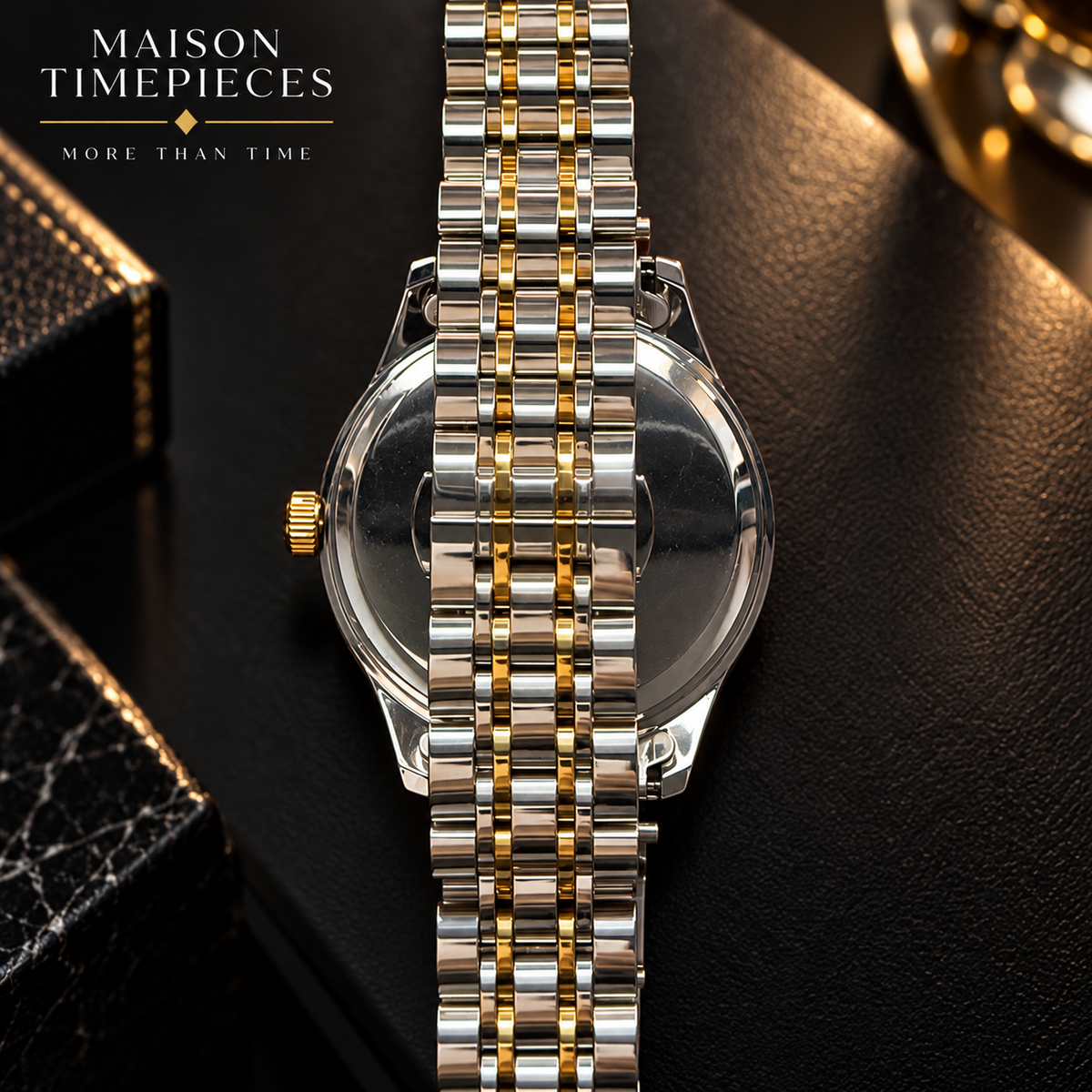 A close-up of a Maison Timepieces watch showing the polished back of the case and two-tone metal bracelet with silver and gold links, set against a dark textured surface with branded logo text in the top left.