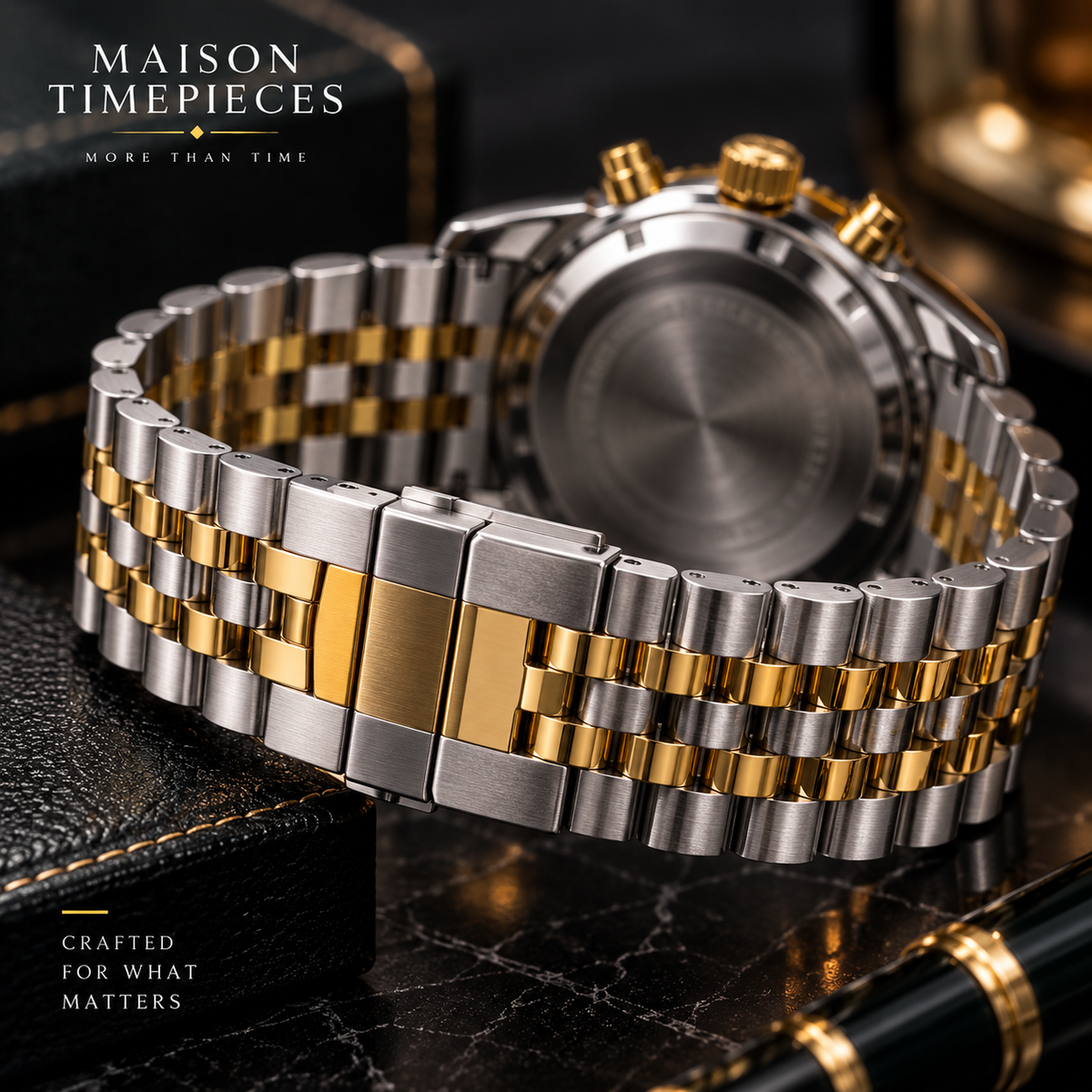 Close-up of two-tone stainless steel and gold-tone watch bracelet and folding clasp